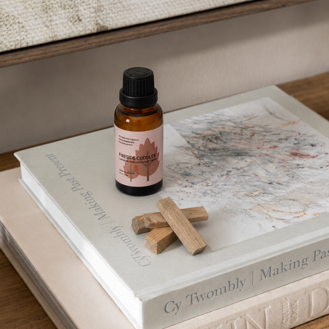 Small bottle with a pink label on top of a book